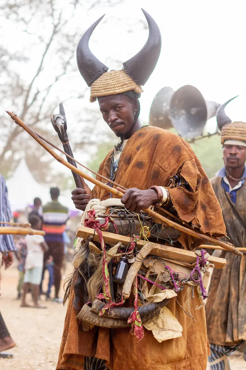 A warrior in a tall horned headdress and leather tunic at Fiok