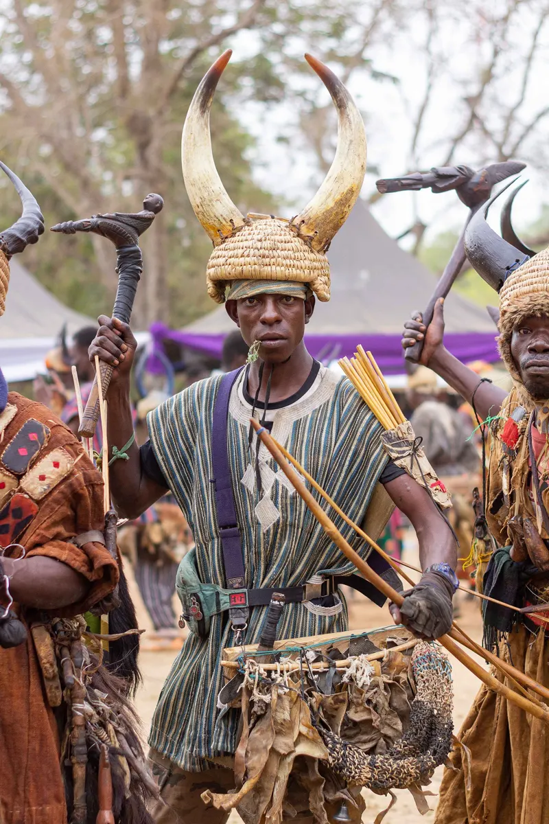 A line of Builsa warriors in headdresses dancing at Fiok