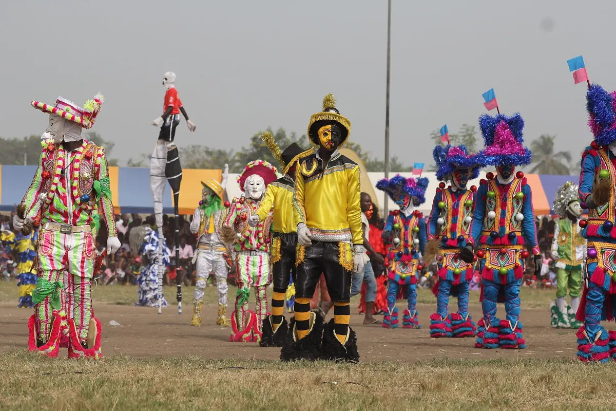 Masquerade clubs in bright costumes on the parade ground at Winneba